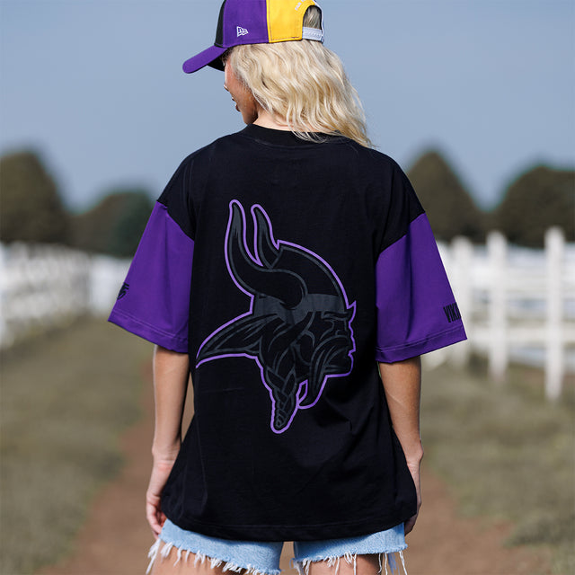 Model wearing the Two-Tone Lax Tee in black and purple, back view